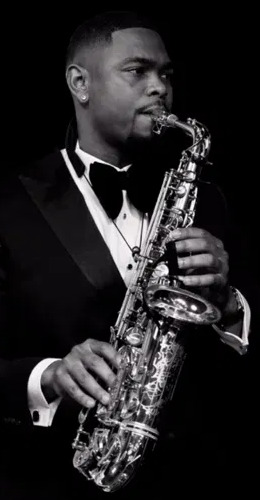 Will Pefok in a tuxedo with alto saxophone
